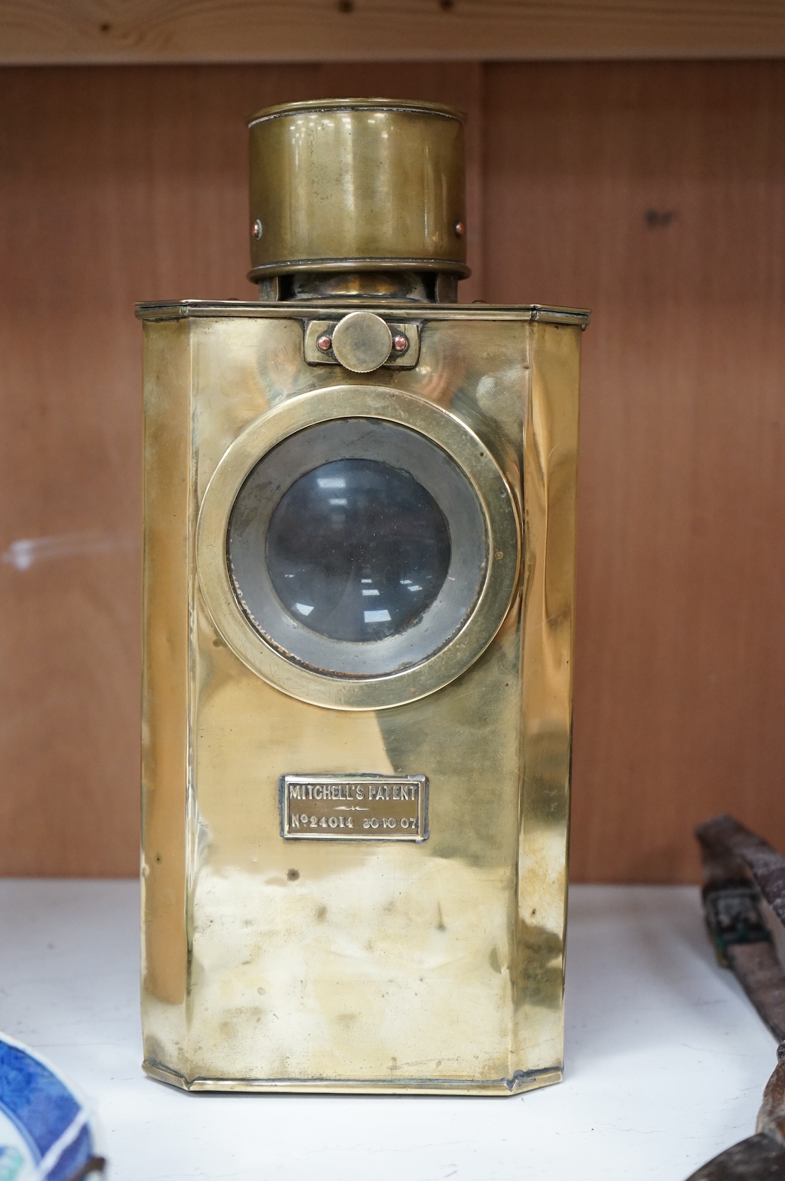 A naval brass Mitchell’s Patent morse code signalling lamp, numbered 24014 and dated 30 10 07, triangular body engraved ‘HMS Dreadnought’ to one face and ‘Admiral’s Barge’ to another, complete with burner and morse code